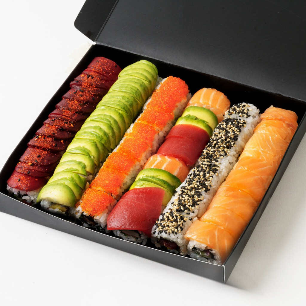 Out of the Blue Sushi - Geisha Platter - containing 48 pieces n iotal of Vegan Hug, Dragon Bean, Silky Salmon, Rainbow Crab, Rebel Tuna, Misty Salmon in black serving box on white background. Allergens: Fish, Dairy, Sesame, Shellfish, Egg, Mustard, Wheat, Barley, Soy in black serving box on white background. Allergens: Fish, Dairy, Sesame, Shellfish, Egg, Mustard, Wheat, Barley, Soy
